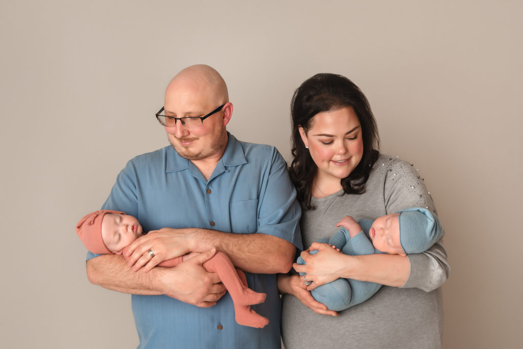 parents hold newborn baby twins during Las Vegas Studio newborn portraits